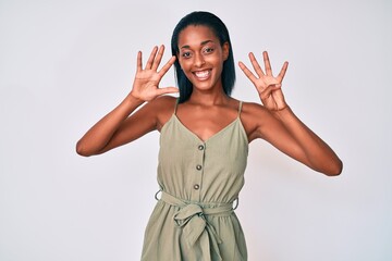 Young african american woman wearing casual clothes showing and pointing up with fingers number...