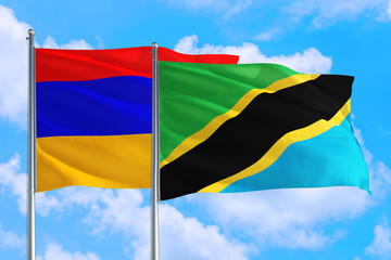 Tanzania and Armenia national flag waving in the windy deep blue sky. Diplomacy and international relations concept.