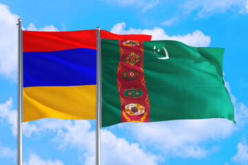 Turkmenistan and Armenia national flag waving in the windy deep blue sky. Diplomacy and international relations concept.