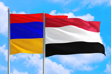 Yemen and Armenia national flag waving in the windy deep blue sky. Diplomacy and international relations concept.