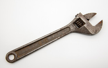 Old rusty Adjustable Wrench on white background.