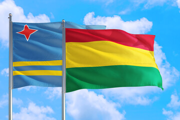 Bolivia and Aruba national flag waving in the windy deep blue sky. Diplomacy and international relations concept.