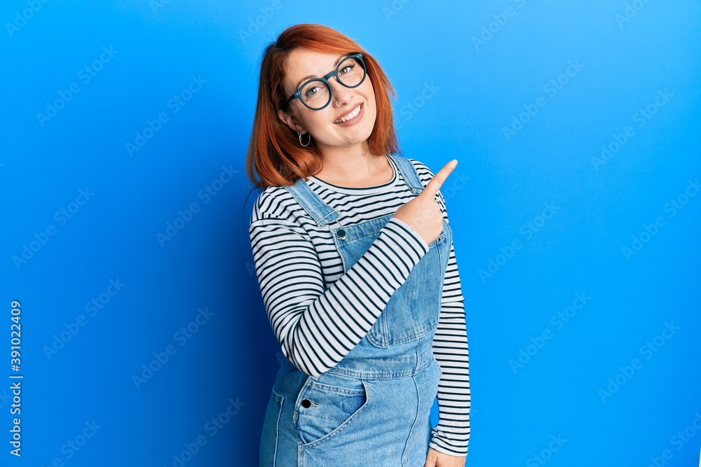 Canvas Prints beautiful redhead woman wearing casual clothes and glasses smiling cheerful pointing with hand and f