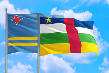 Central African Republic and Aruba national flag waving in the windy deep blue sky. Diplomacy and international relations concept.
