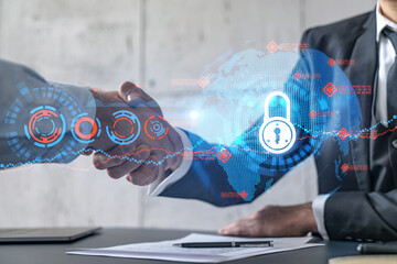 Multiexposure of two businesspeople handshake and lock icon hologram drawing background. Concept of...