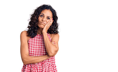 Middle age beautiful woman wearing casual sleeveless t shirt thinking looking tired and bored with depression problems with crossed arms.