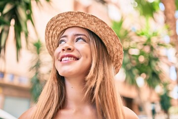 Young caucasian tourist girl smiling happy walking at the city.