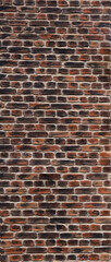 
An old brick wall made of bricks of an unusual color.