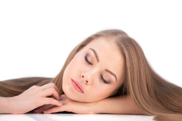 Obraz premium Young Healthy Woman with Long Hair and Closed Eyes Lies on White Isolated Background