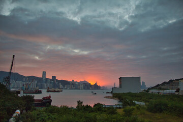 Fototapeta na wymiar city skyline at sunset, view of Victoria Harbour, from Yau Tong, Kowloon, Hong Kong