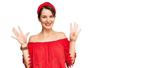 Young brunette woman with short hair wearing casual summer clothes and diadem showing and pointing...