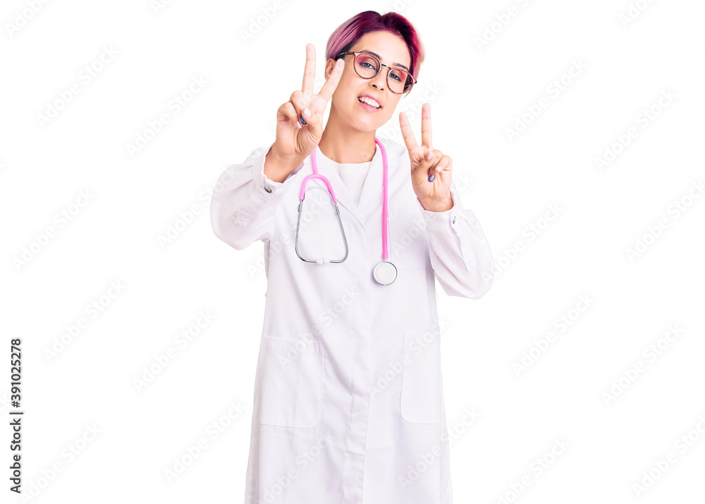 Sticker young beautiful woman with pink hair wearing doctor uniform smiling looking to the camera showing fi