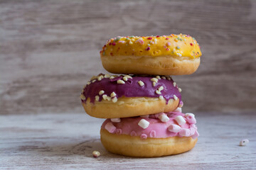 Stacked Glazed Donuts.
 A Pile Of Colorful Donuts.