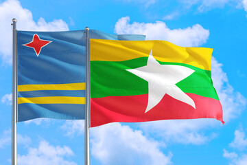 Myanmar and Aruba national flag waving in the windy deep blue sky. Diplomacy and international relations concept.