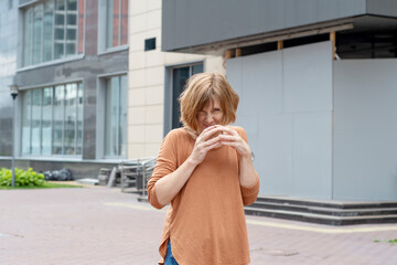 An adult redhead woman in casual clothes with a sly and ominously expression and steepled fingers....