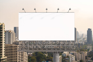 Blank white road billboard with Bangkok cityscape background at day time. Street advertising poster, mock up, 3D rendering. Front view. The concept of marketing communication to promote or sell idea.