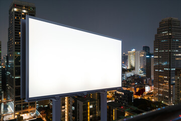 Blank white road billboard with Bangkok cityscape background at night time. Street advertising poster, mock up, 3D rendering. Side view. The concept of marketing communication to sell idea.