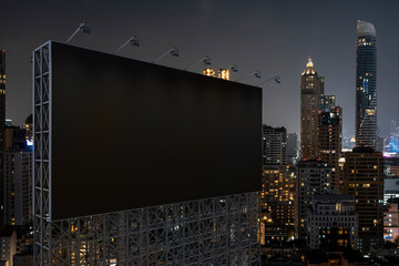 Blank black road billboard with Bangkok cityscape background at night time. Street advertising poster, mock up, 3D rendering. Side view. The concept of marketing communication to promote idea. © VideoFlow