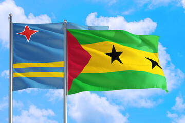 Sao Tome And Principe and Aruba national flag waving in the windy deep blue sky. Diplomacy and international relations concept.