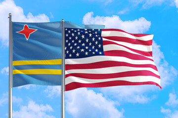 United States and Aruba national flag waving in the windy deep blue sky. Diplomacy and international relations concept.