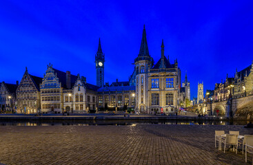 View of Graslei, Korenlei quays, Leie river and St Michael's bridge in the historic city center in Ghent (Gent), Belgium. Architecture and landmark of Ghent. Night cityscape of Ghent.