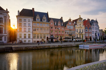 Fototapeta na wymiar View of Korenlei quay and Leie river in the historic city center in Ghent (Gent), Belgium. Architecture and landmark of Ghent. Sunset cityscape of Ghent.