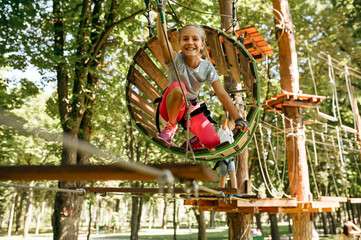 Teens in equipment climbs in rope park, playground