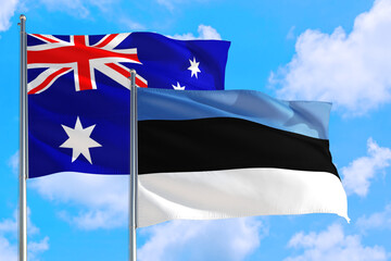 Estonia and Australia national flag waving in the windy deep blue sky. Diplomacy and international relations concept.