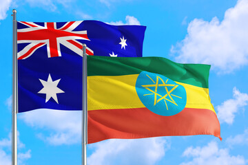 Ethiopia and Australia national flag waving in the windy deep blue sky. Diplomacy and international relations concept.