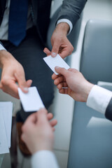 close up.business people exchanging business cards