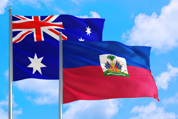 Haiti and Australia national flag waving in the windy deep blue sky. Diplomacy and international relations concept.