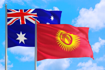 Kyrgyzstan and Australia national flag waving in the windy deep blue sky. Diplomacy and international relations concept.