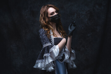Fototapeta na wymiar Beautiful woman in renaissance dress, face mask and gloves on abstract dark background