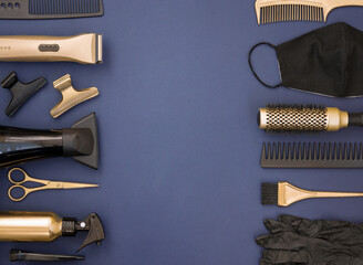 Hairdressing tools in gold and black on a blue background. Frame of Barber shop items, scissors,...