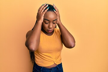 Young african american woman wearing casual clothes suffering from headache desperate and stressed because pain and migraine. hands on head.