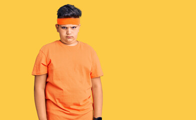 Little boy kid wearing sportswear skeptic and nervous, frowning upset because of problem. negative person.