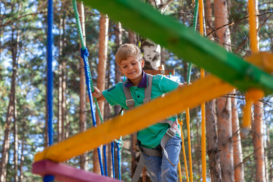 A young tourist trains on a hanging rope structure.
