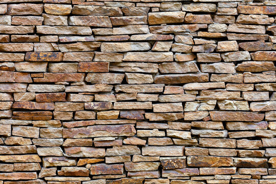 The texture of the wall is lined with sandstone, high resolution.