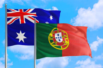 Portugal and Australia national flag waving in the windy deep blue sky. Diplomacy and international relations concept.