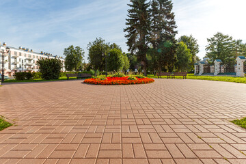Urban recreation area with a flowerbed and paving slabs.