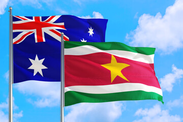 Suriname and Australia national flag waving in the windy deep blue sky. Diplomacy and international relations concept.