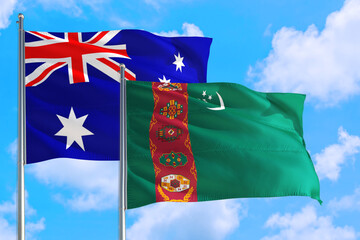 Turkmenistan and Australia national flag waving in the windy deep blue sky. Diplomacy and international relations concept.