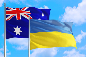 Ukraine and Australia national flag waving in the windy deep blue sky. Diplomacy and international relations concept.