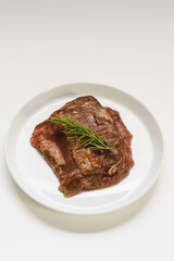 Red meat chunks in a wooden plate.