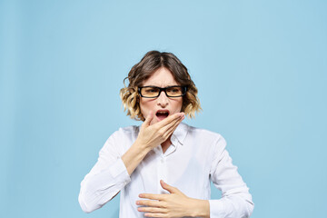 Business woman in a light shirt on a blue background gestures with her hands emotions model work