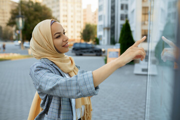 Arab female student looking on map in downtown