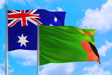 Zambia and Australia national flag waving in the windy deep blue sky. Diplomacy and international relations concept.
