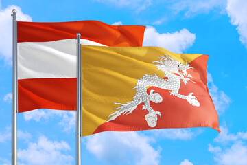 Bhutan and Austria national flag waving in the windy deep blue sky. Diplomacy and international...