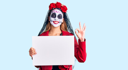 Woman wearing day of the dead costume holding blank empty banner doing ok sign with fingers, smiling friendly gesturing excellent symbol