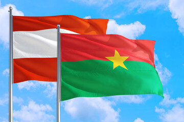 Fototapeta na wymiar Burkina Faso and Austria national flag waving in the windy deep blue sky. Diplomacy and international relations concept.